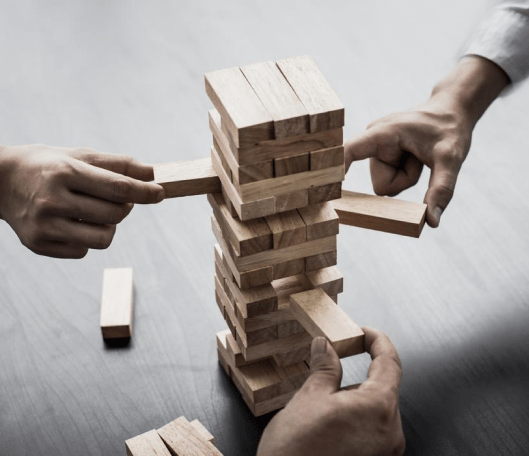 A stack of wooden blocks sitting on top of each other on a table.