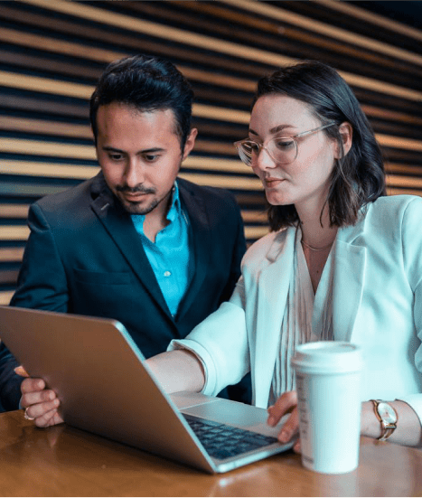 2 people working on a laptop